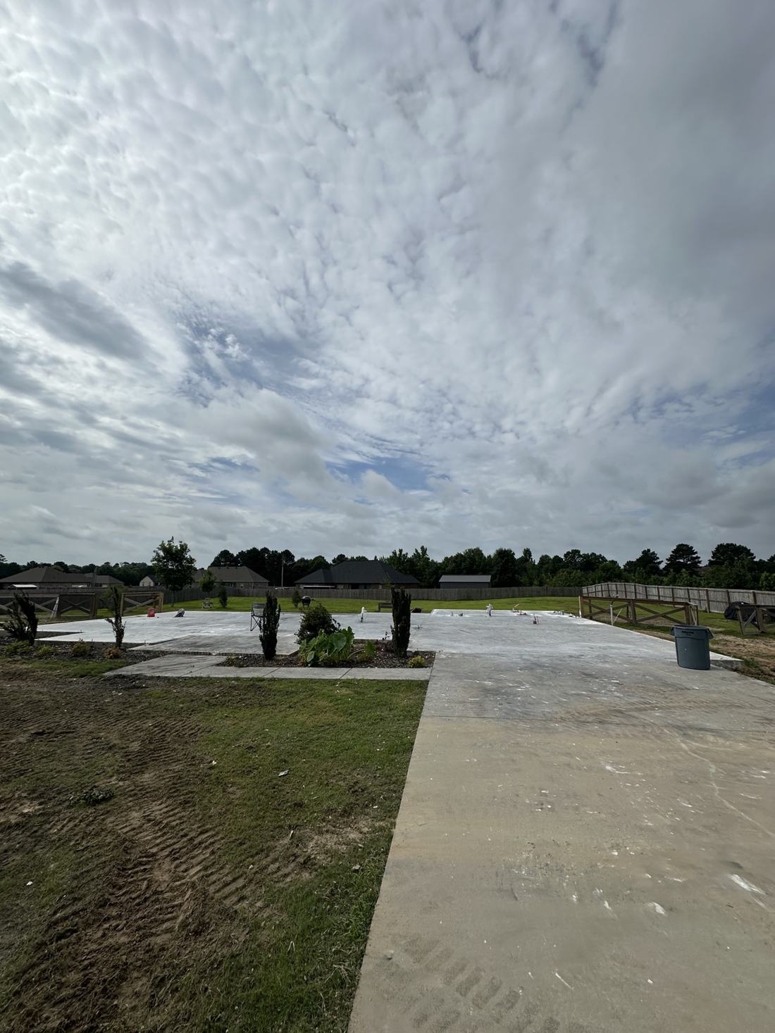 The same East End property after Bratchco removed the burned house — clean slab and driveway left ready for a new home